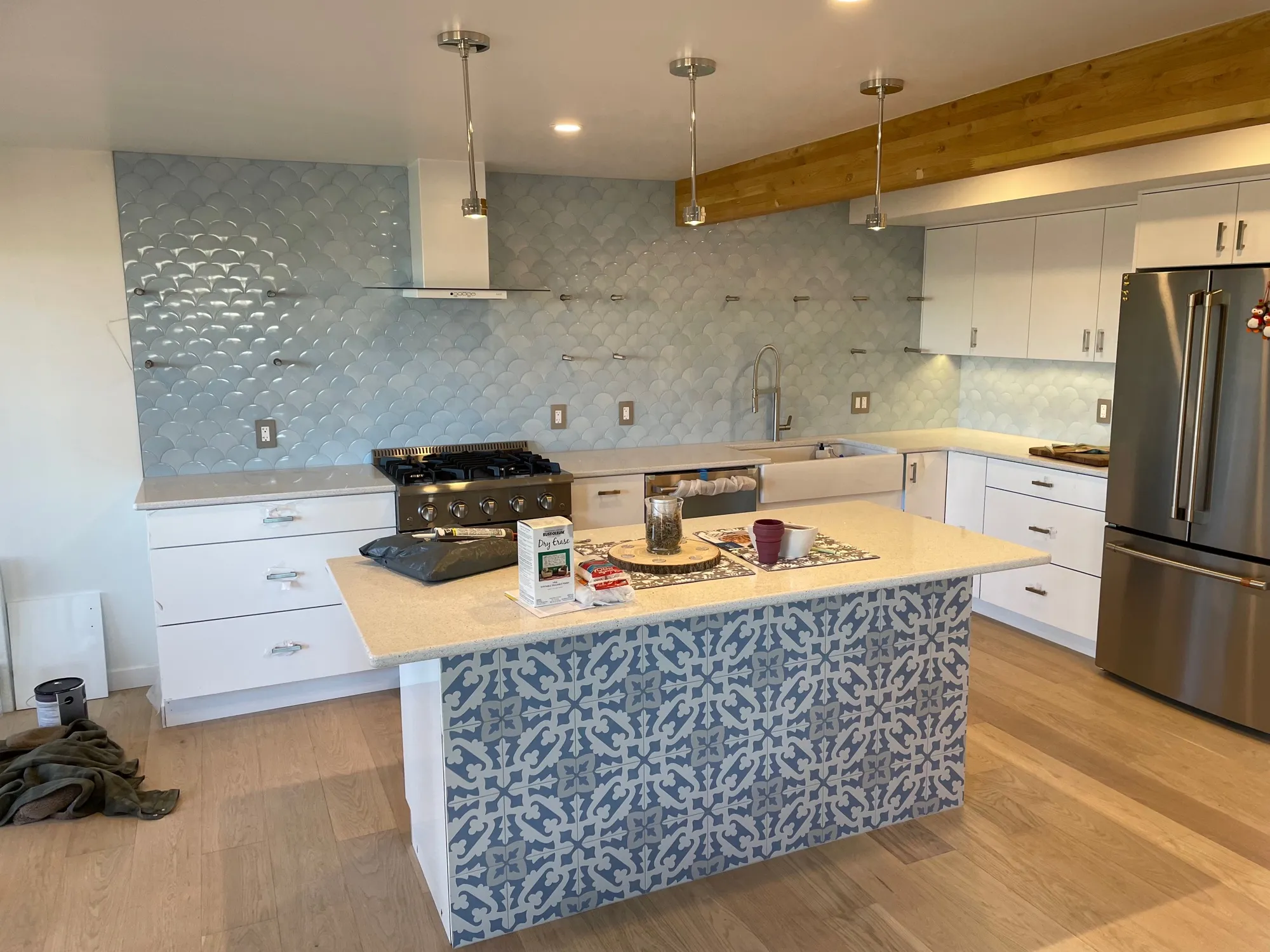 Kitchen with a light-blue fish-scale tile backsplash and a blue-and-white Moroccan-pattern tile island